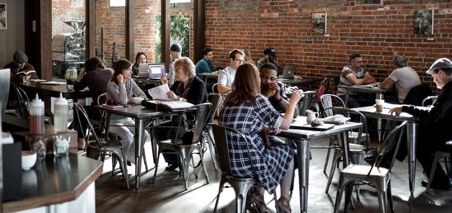 people sitting on restaurant chairs